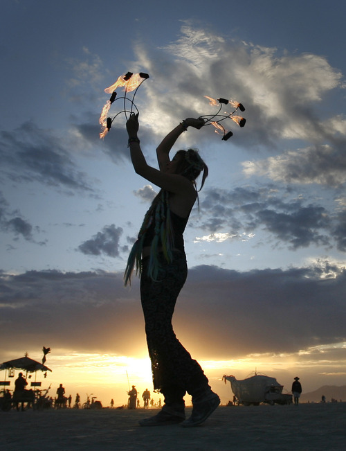 Rick Egan  | The Salt Lake Tribune 
Ali Luminesence dances at sunrise Thursday at Burning Man, the annual arts festival in the Black Rock Desert in Nevada.