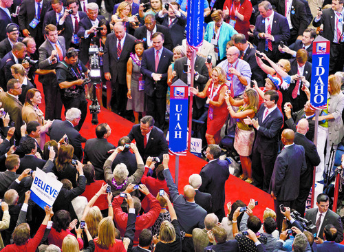 Trent Nelson  |  The Salt Lake Tribune
Mitt Romney shakes hands as he makes his entrance at the Republican National Convention in Tampa, Florida, Thursday, August 30, 2012.