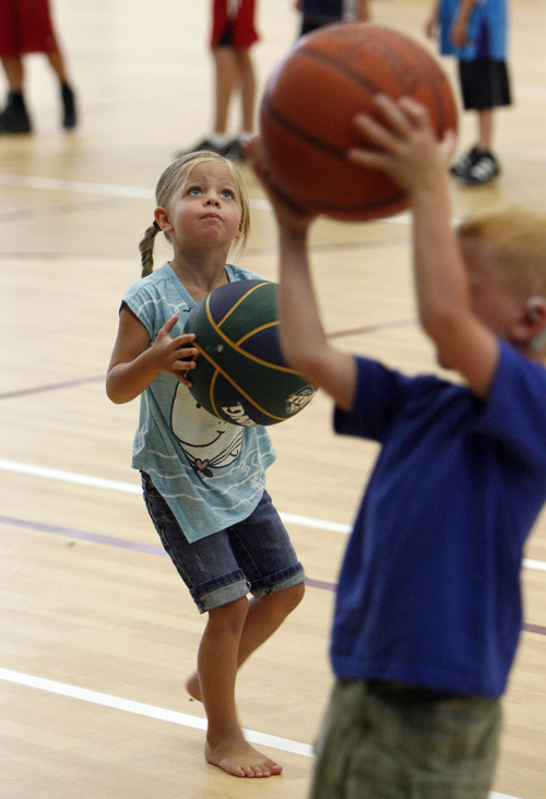 Francisco Kjolseth  |  The Salt Lake Tribune
Aubryn Jones, 4, of Croyden eyes her chances at reaching the baskte as Jazz forward DeMarre Carroll participated in Junior Jazz at the Trojan Century Center in Morgan, Utah on Monday, August 6, 2012. Dozens of boys and girls from all age groups had a chance to learn about the 6'8
