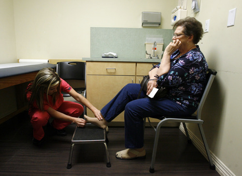 Francisco Kjolseth  |  The Salt Lake Tribune
Medical assistant Nikki Torgerson of CopperView Medical Center in South Jordan tests Dolores Drayer, 69, for neuropathy, making sure she hasn't lost sensation in her feet, a risk for people with diabetes. The clinic is part of the federally-funded Beacon project, which helps clinics use patient data to drive care -- such as identifying patients who have been shirking office visits and blood sugar screens.