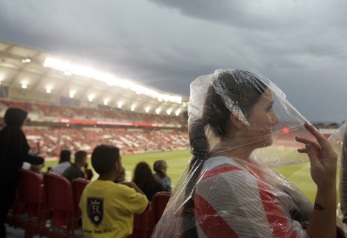Kim Raff | The Salt Lake Tribune
Real Salt Lake fan Katie Zampedri waits for a thunderstorm to pass that delayed the game against D.C. United at Rio Tinto Stadium in Sandy, Utah on September 1, 2012.