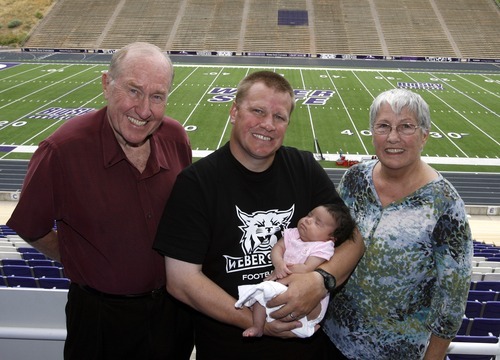 Rick Egan  | The Salt Lake Tribune 

Ted Stanley, stands with his son Ted Stanley, who is holding his daughter, Emmerson (center) along his mother, Mary Ann (right) at Weber State, Friday, August 10, 2012. Ted Stanley, a Weber State assistant football coach, is raising his infant, following the childbirth-related death of his wife, Jocelyn. His parents,, are helping him.