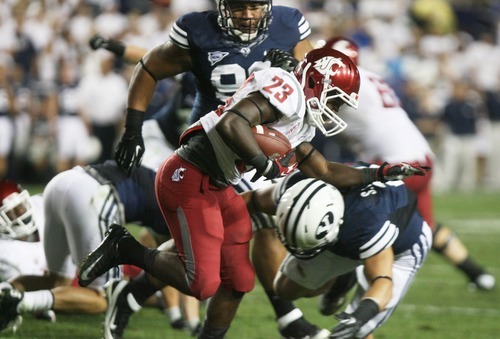Kim Raff | The Salt Lake Tribune
Washington State Cougars running back Leon Brooks (23) is tackled by Brigham Young Cougars linebacker Spencer Hadley (2) during BYU's home opener at LaVell Edwards Stadium in Provo, Utah on August 30, 2012.