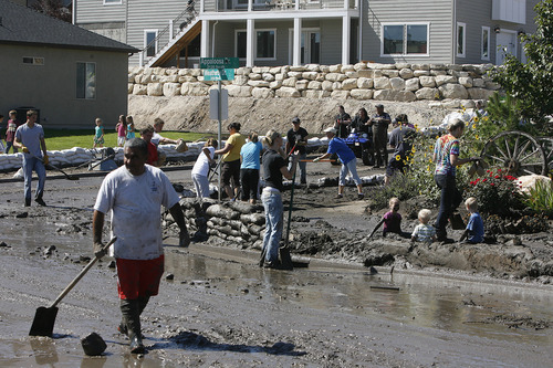 Scott Sommerdorf  |  The Salt Lake Tribune             
The scene at the intersection of Appaloosa and Weatherby Drives in Saratoga Springs, as neighbors and other volunteers pitch in to help the homeowners affected by the flood, Sunday, September 2, 2012.