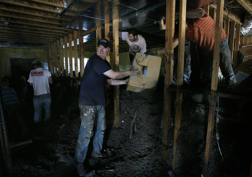 Scott Sommerdorf  |  The Salt Lake Tribune             
Neighbors and other volunteers work to empty out valuables and the nearly four feet of accumulated mud and hail in the unfinished basement of Russell Greene's home on Ruger Drive, in Saratoga Springs, Sunday, September 2, 2012.