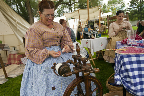 Chris Detrick  |  The Salt Lake Tribune
Tracy Mutter, of Magna, spins wool during Camp Floyd Days at Camp Floyd State Park in Fairfield Saturday September 1, 2012. The event will allow visitors to experience camp life and participate in several activities performed by soldiers of Johnston's Army. Events include reenactments, encampments, stagecoach rides (Monday 12pm – 2pm), firearm and cannon demonstrations, marches, drills, 1861 period games, and photos in period uniform. The events will be conducted 10 a.m. to 4 p.m. on both days. Standard museum entrance fees are $2 per person or $6 per family.