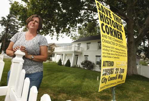 Leah Hogsten  |  The Salt Lake Tribune
Karen Hainsworth Johnson stands in front of her family's historic house in Centerville. She and her family oppose Centerville city's plan to slice off a huge chunk of the front yard of the home, which has been in her family since 1864, to widen Main Street in an effort to lessen traffic congestion at Parrish Lane.