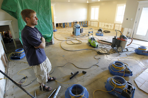 Al Hartmann  |  The Salt Lake Tribune
Gavin McClellan takes a breath after emptying his basement family room that filled with mud from Saturday's flash flood. He had multiple fans blowing to dry out the basement on Tuesday, Sept. 4.