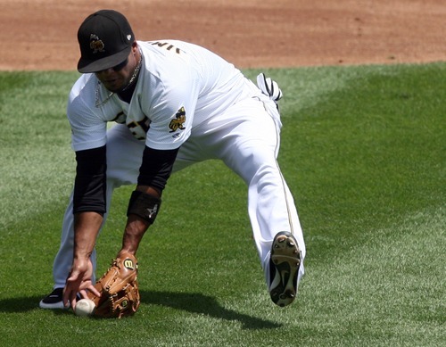 Kim Raff | The Salt Lake Tribune
Salt Lake Bees third baseman Luis Jimenez scoops up a bunt during a  game agasint the Fresno Grizzlies at Spring Mobile Ballpark in Salt Lake City on July 22, 2012.