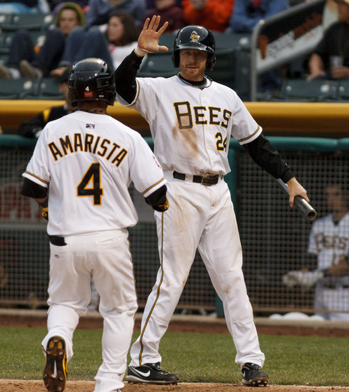 Trent Nelson  |  The Salt Lake Tribune
Salt Lake's Doug Deeds (24) high-fives teammate Alexi Amarista after both scored on a Andrew Romine double in the fourth inning at Salt Lake Bees vs. Reno Aces baseball Friday, April 27, 2012 at Spring Mobile Ballpark in Salt Lake City.