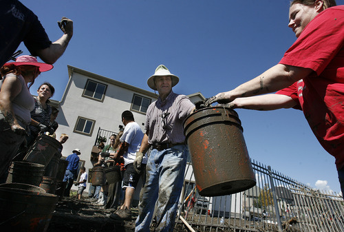 Scott Sommerdorf  |  The Salt Lake Tribune             
Neighbors and other volunteers pitch in to help empty the basement of mud and debris at the home hardest hit on Weatherby Drive in Saratoga Springs, Sunday, September 2, 2012.