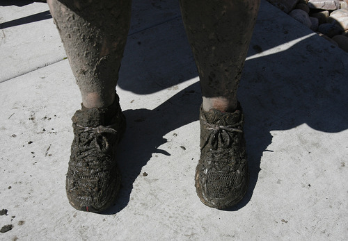 Scott Sommerdorf  |  The Salt Lake Tribune             
Karin Robe's feet show the effects of volunteering to help clean out homes  affected by the flood near the intersection of Appaloosa and Weatherby Drives in Saratoga Springs, Sunday, September 2, 2012.