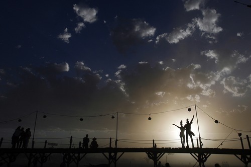 Rick Egan  | The Salt Lake Tribune 
Burning man revelers wave to friends from 