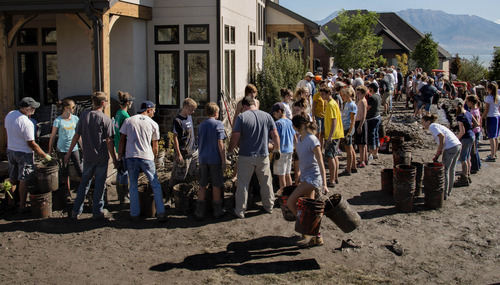 Douglas C. Pizac  |  Special to The SAlt Lake Tribune

Volunteers formed two bucket brigades from the basement to the street during the cleanup of a home flooded by hillside run off Monday, Sept. 3, 2012, in Saratoga Springs, Utah.