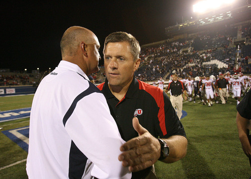Scott Sommerdorf  |  The Salt Lake Tribune

Utah State head coach Brent Guy (L), speaks to Utah Head coach Kyle Whittingham after the blowout loss Saturday, 9/13/08. The Utes defeated Utah State 58-10.
