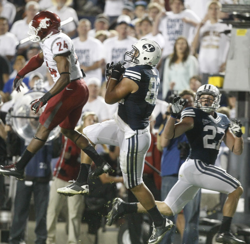 Chris Detrick  |  The Salt Lake Tribune
Brigham Young Cougars tight end Kaneakua Friel (82) makes a touchdown catch past Washington State Cougars cornerback Daniel Simmons (24) during the first half of the game against Washington State at LaVell Edwards Stadium in Provo on Thursday, Aug. 30, 2012.