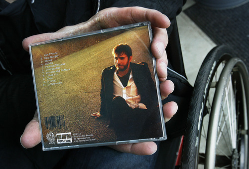 Tribune file photo
Joel Brown, photographed here in 2011, holds the CD case for his album, which was released by Spy Hop Productions' local record label in 2011. Joel has been paralyzed since he was 9.