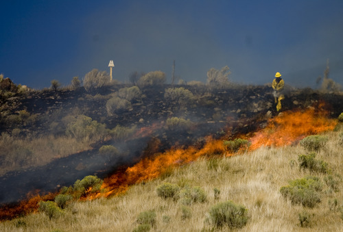 Kim Raff | The Salt Lake Tribune
Firefighters work to contain a brush fire flare up in Wanship, Utah on September 5, 2012.  The fast moving brush fire forced some residents to evacuate.