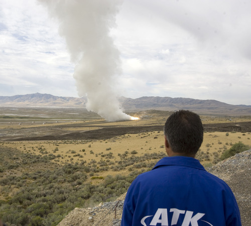 Al Hartmann  |  The Salt Lake Tribune
An Alliant Techsystems employee watches the GEM-60 solid rocket motor testing from one-half mile away Thursday, Sept. 6, at ATK's testing facility west of Brigham City. The 60-inch diameter graphite epoxy motor is a commercially provided low-cost propulsion system.