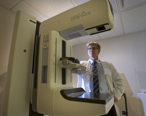 Paul Fraughton  |  The Salt Lake Tribune  
Radiologist Brett Parkinson MD stands next to Intermountain Medical Center's  mammogram unit that creates 3D mammograms in this 2011 photo.