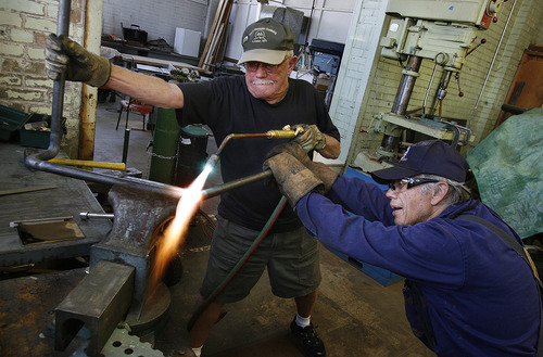 Scott Sommerdorf  |  The Salt Lake Tribune             
Richard Carroll, left, and Bob Wachs work on bending a shaft of steel to make a decoupler arm for the locomotive they are working to restore. A group of volunteers in Ogden comes together every Saturday to work on restoring a narrow gauge locomotive at the Union Station Trainmen's Building, Saturday, September 8, 2012.