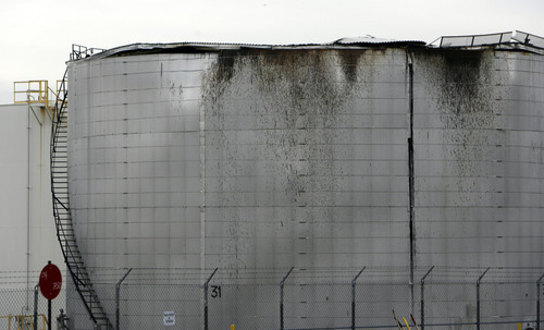 Francisco Kjolseth  |  The Salt Lake Tribune
A cracked top on a Woods Cross refinery storage tank spread an unspecified amount of thick oil overnight, coating businesses east of the Holly Oil Refinery in a black spray that could take days to clean up.