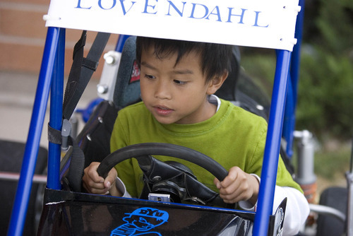 Paul Fraughton | Salt Lake Tribune
Isaiah Heng, a first grader at Silver Hills Elementary School in Kearns, sits behind the wheel of  The pair joined students and families at for a PTA event  where race drivers from Rocky Mountain Raceway  brought their  race cars to the school so kids could get an up close experience with the unique machines.
 Monday, September 10, 2012