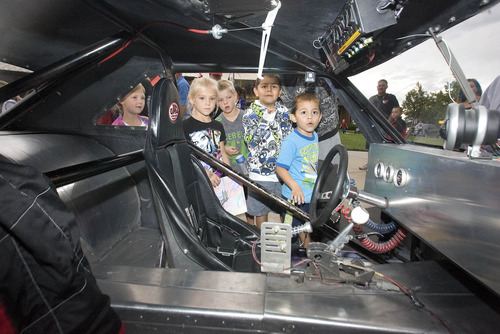 Paul Fraughton | Salt Lake Tribune
 Youngsters peek inside a dragster on display at  Silver Hills Elementary School in Kearns. Race cars and drivers from Rocky Mountain Raceway  brought their  race cars to the school so kids could get an up close experience with the unique machines.The event was sponsored by the school's PTA.
 Monday, September 10, 2012