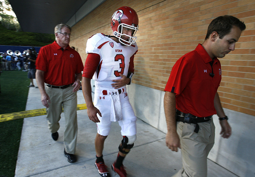 Utah quarterback Jordan Wynn heads to the locker room before halftime after he injured his left shoulder on a sack late in the second quarter against Utah State during an NCAA college football game Friday, Sept. 7, 2012, in Logan. (AP Photo/The Salt Lake Tribune, Scott Sommerdorf)