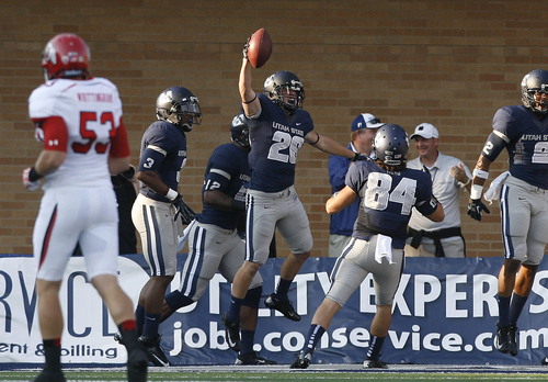 Utah State's Clayton Christensen celebrates after he recovered a blocked Utah punt in the end zone early in an NCAA college football game Friday, Sept. 7, 2012, in Logan, Utah. (AP Photo/The Salt Lake Tribune, Scott Sommerdorf) DESERET NEWS OUT  MAGS OUT