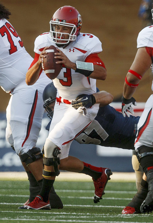 Utah quarterback Jordan Wynn is sacked by a Utah State player during the first quarter of an NCAA college football game Friday, Sept. 7, 2012, in Logan, Utah. (AP Photo/The Salt Lake Tribune, Trent Nelson) DESERET NEWS OUT  MAGS OUT
