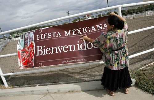 Francisco Kjolseth  |  The Salt Lake Tribune
Anita Watson, event coordinator for Fiesta Mexicana at the state fair, puts up a banner to draw attention to the event.