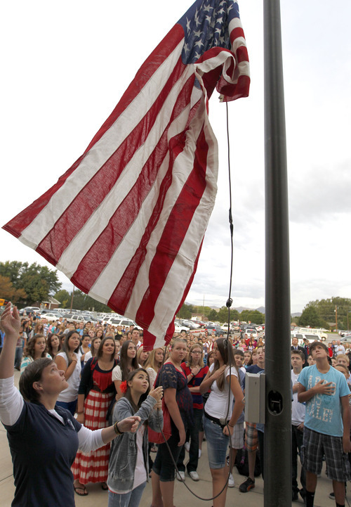 Al Hartmann  |  The Salt Lake Tribune
Hundreds of students gather to raise the American flag in a Sunrise Salute to Patriots at South Jordan Middle School on Tuesday. Students sang a number of patriotic songs as they  gathered around the flag pole in a tribute to 9/11 victims.