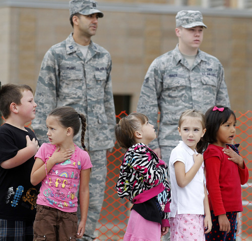 Al Hartmann  |  The Salt Lake Tribune
Wasatch Elementary students stand with military personnel from Hill Air Force Base during a flag ceremony in Clearfield on Tuesday. An American flag that has flown over the USS Arizona at Pearl Harbor, Hill Air Force Base and the U.S. Capitol was presented to the school.