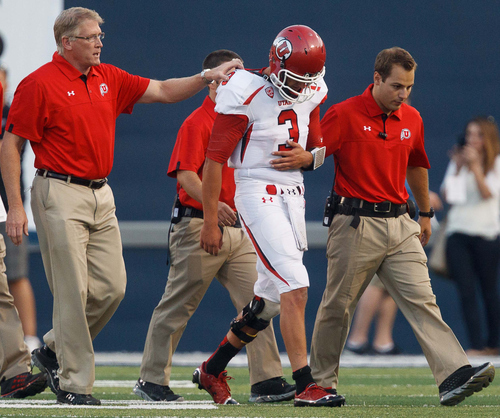 An injured Jordan Wynn leaves the field during the second quarter against Utah State on Friday, Sept. 7, 2012, in Logan, Utah. (AP Photo/The Salt Lake Tribune, Trent Nelson)