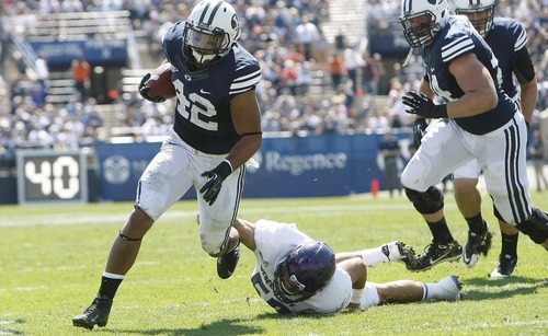 Chris Detrick  |  The Salt Lake Tribune
Brigham Young Cougars running back Michael Alisa (42) runs for a touchdown past Weber State Wildcats linebacker Roman Valenzuela (50) during the first half of the game against Weber State at LaVell Edwards Stadium Saturday September 8, 2012. BYU is winning the game 21-0.