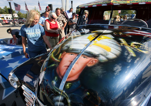 Steve Griffin | The Salt Lake Tribune
Julie Vinnedge, mother of Lance Cpl. Phillip David Vinnedge, who died while serving in Afghanistan, gives people a tour of a vintage truck she, and her husband Dave Vinnedge, restored in honor of their son during an event at Fairbourne Station Plaza, in West Valley City, Utah Tuesday September 11, 2012. The Vinnedge's fulfilled his dream of restoring a 1951 Chevy truck complete with murals honoring him, his family, his military colleagues and those lost on September 11, 2001. Lance Cpl. Vinnedge's parents now travel and display the truck in memory of their son. They will be in Camp Pendleton Sept. 13, 2012 to show the truck to his son's platoon. Phillip was deployed with the 3rd Battalion, 5th Marine Regiment to Afghanistan and on October 13, 2010 Phillip was driving the lead vehicle on a security patrol with Lcpl Victor Dew, Lcpl Joe Rodewald and Cpl Justin Cain when a large IED was remotely detonated killing all 4 instantly. The four soldiers are painted on the driver side door pictured here.