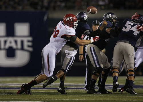 Scott Sommerdorf  |  The Salt Lake Tribune             
Utah DL Joe Kruger hits USU QB Chuckie Keeton from behind and causes this fumble that was recovered by Utah's Nate Fakahafua during second half play. Later Kruger was thrown out of the game for fighting. The USU Aggies beat Utah 27-20 in OT, Friday, September 7, 2012.