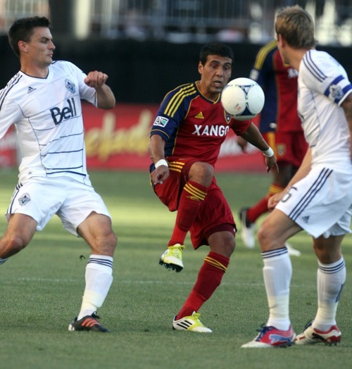 Kim Raff | The Salt Lake Tribune
Real Salt Lake player Javier Morales maintains control of the ball against Vancouver player (left) Alain Rochat at Rio Tinto Stadium in Sandy, Utah on July 27, 2012.