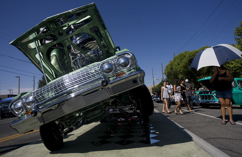 Kim Raff | The Salt Lake Tribune
People walk past Patrick Evje's 1963 Chevrolet Impala convertible during the El Grito de la Independencia, Mexico's official independence day, festival and car show at Centro Civico Mexicano in Salt Lake City, Utah on September 16, 2012.