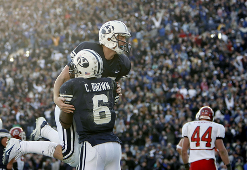 Chris Detrick | The Salt Lake Tribune

BYU quarterback John Beck leaps into the arms of Curtis Brown after completing a touchdown. Beck threw for 309 yards with two touchdowns as Utah faced BYU at LaVell Edwards stadium. Utah won 41-34 in overtime.