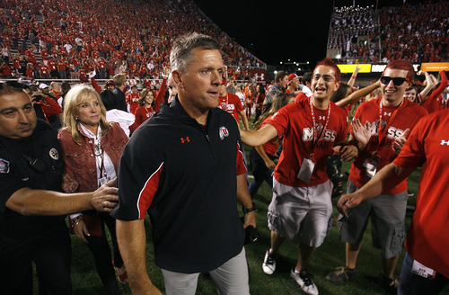 Scott Sommerdorf  |  The Salt Lake Tribune             
Utah coach Kyle Whittingham heads out to the field after the win to look for Bronco Mendenhall. Utah defeated BYU 24-21, Saturday, September 15, 2012.