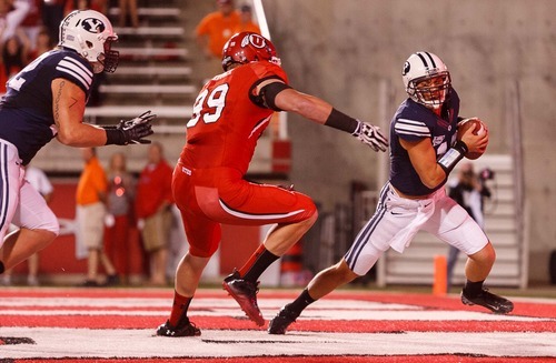 Trent Nelson  |  The Salt Lake Tribune
Utah defensive end Joe Kruger (99) brings down Brigham Young quarterback Riley Nelson (13) for what would have been a safety but a face mask penalty was called during the game in Salt Lake City on Saturday, Sept. 15, 2012.