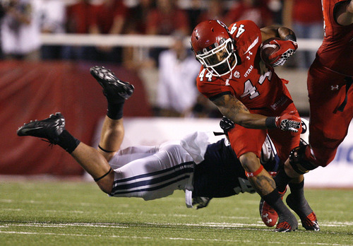Scott Sommerdorf  |  The Salt Lake Tribune             
Utah Utes running back Lucky Radley (44) is tackled during one of his two first half carries. Utah was tied with BYU 7-7 at the half, Saturday, September 15, 2012.