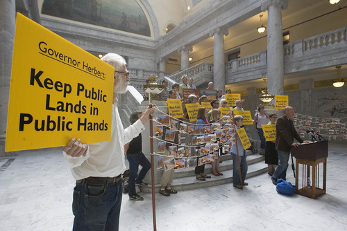 Paul Fraughton | Salt Lake Tribune
A group of Utahns  concerned about Gov. Gary Herbert's support for  the Transfer of Public Lands Act and other  public land issues stand in the capitol rotunda  holding signs and voicing their opposition to the Governor's  policies.  With them they had a petition and postcards with more than 5400 signatures supporting their opposition.

 Wednesday, September 12, 2012