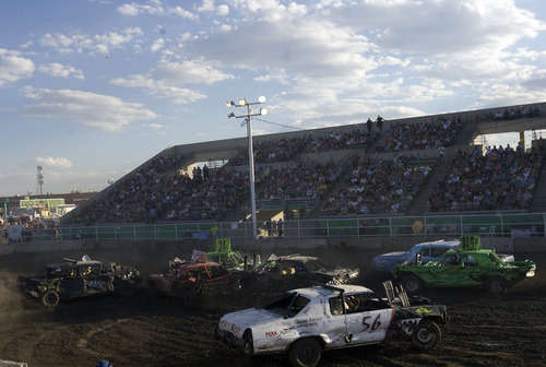 Kim Raff |  The Salt Lake Tribune
Drivers compete in a heat during the Demolition Derby on the last day of the Utah State Fair in Salt Lake City on Sept. 16, 2012.