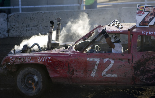 Kim Raff |  The Salt Lake Tribune
Dennis Sandoval, from the Sandoval Boyz team, competes during the Demolition Derby on the last day of the Utah State Fair in Salt Lake City on Sept. 16, 2012.