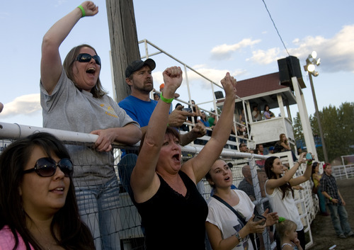 Kim Raff |  The Salt Lake Tribune
Family members of Dalton Gullo cheer him on as he competes in the Demolition Derby on the last day of the Utah State Fair in Salt Lake City on Sept. 16, 2012.