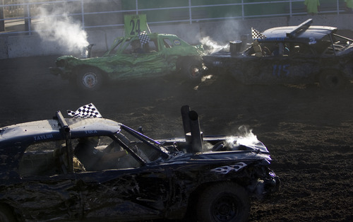 Kim Raff |  The Salt Lake Tribune
Drivers compete in a heat during the Demolition Derby on the last day of the Utah State Fair in Salt Lake City, Utah on September 16, 2012.
