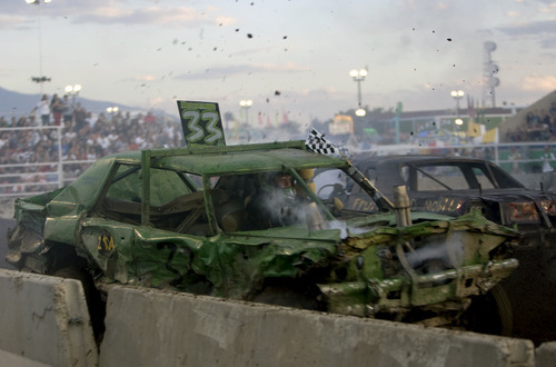 Kim Raff |  The Salt Lake Tribune
Contestants battle it out for a sold-out crowd during the Demolition Derby on the last day of the Utah State Fair in Salt Lake City on Sept. 16, 2012.